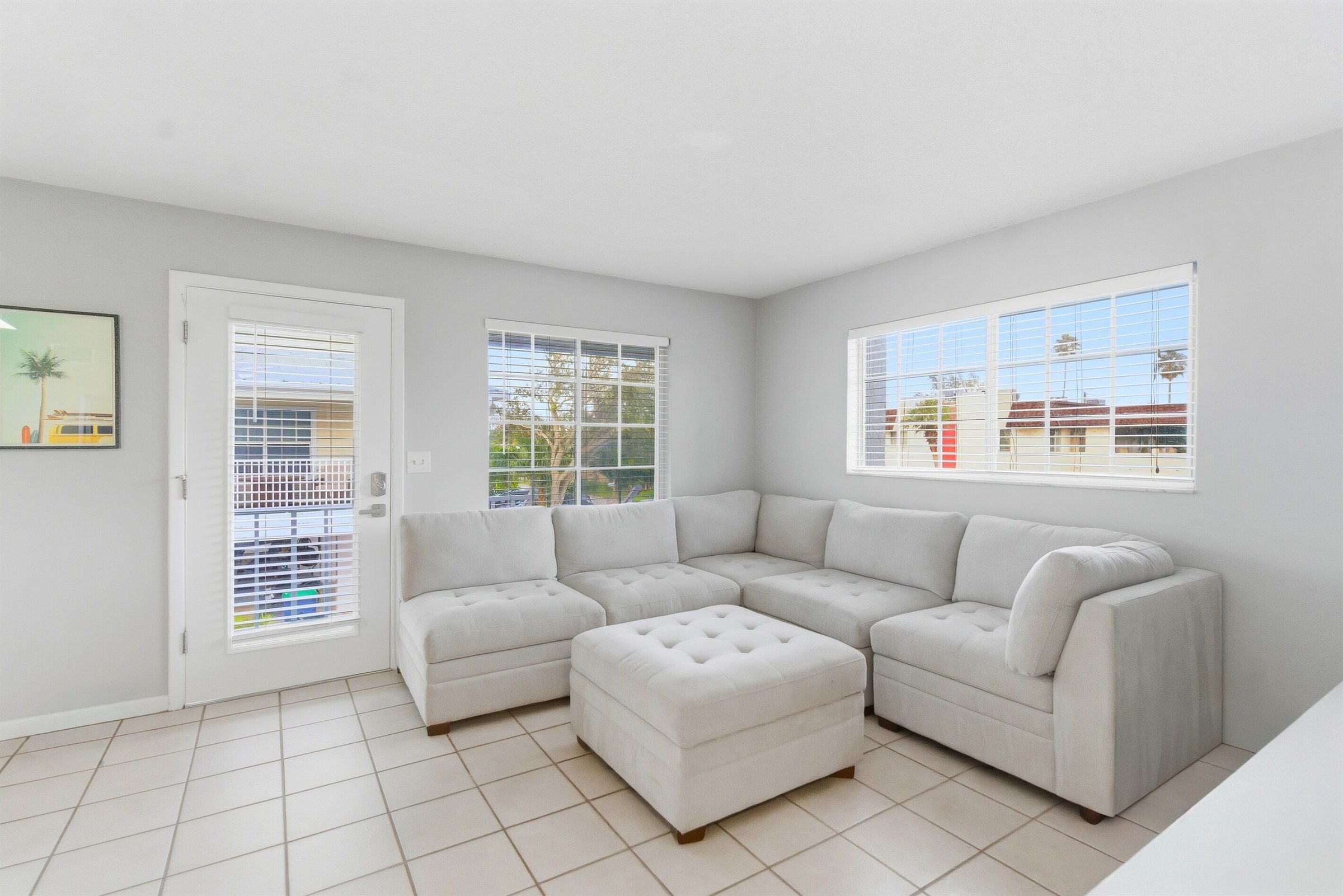 Coastal Boutique Unit 3 living room with a sectional and bright windows