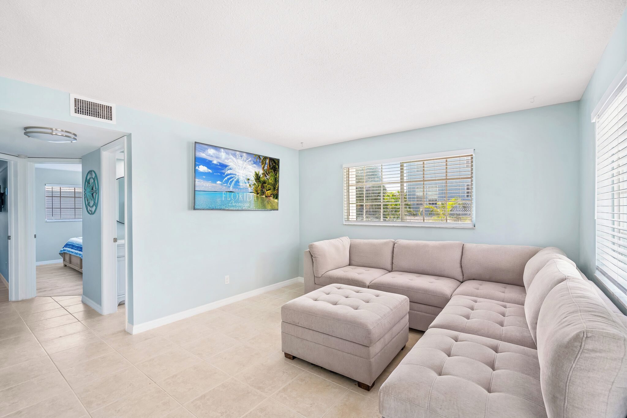 Coastal Boutique Unit 4 living room with a sectional sofa and ottoman
