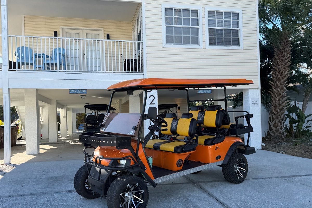 Coastal Getaway golf cart parked under the building