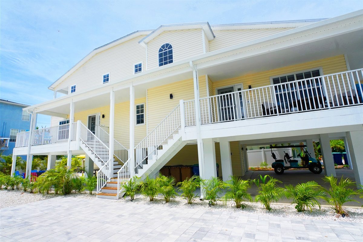 Coastal Getaway exterior with porches and a staircase
