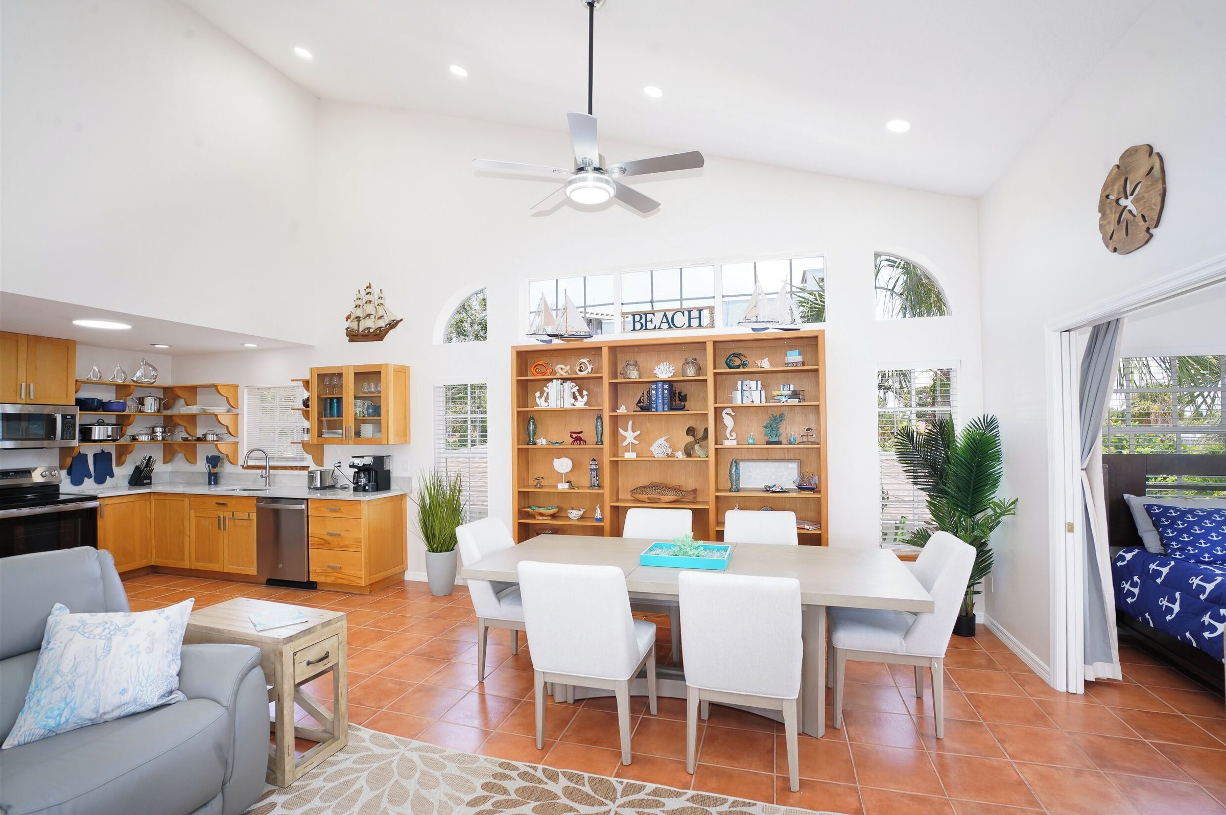 Coastal Getaway living room with a dining table and the kitchen beyond