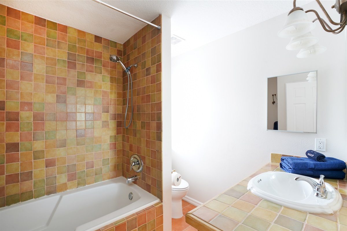 Bathroom with a tub and shower at Coastal Getaway