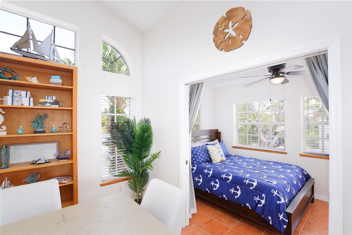 Bedroom with nautical bedding off the living area at Coastal Getaway