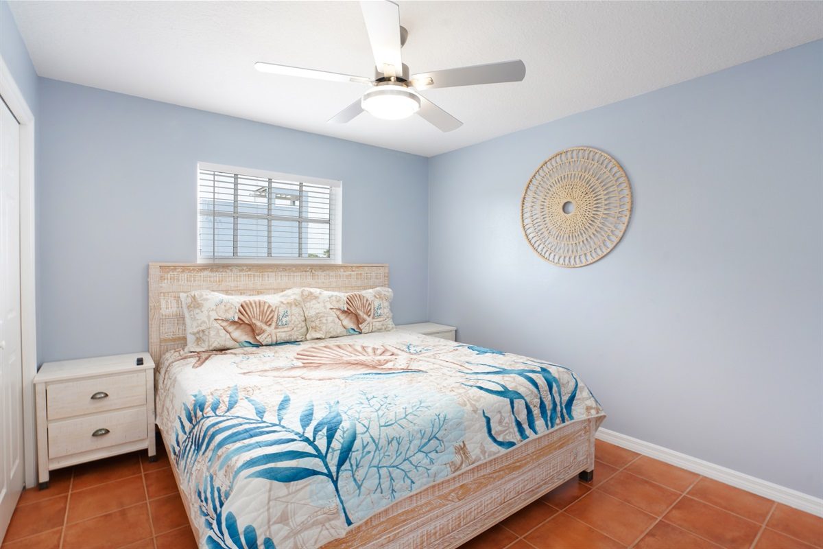 Queen bedroom with coastal bedding at Coastal Getaway