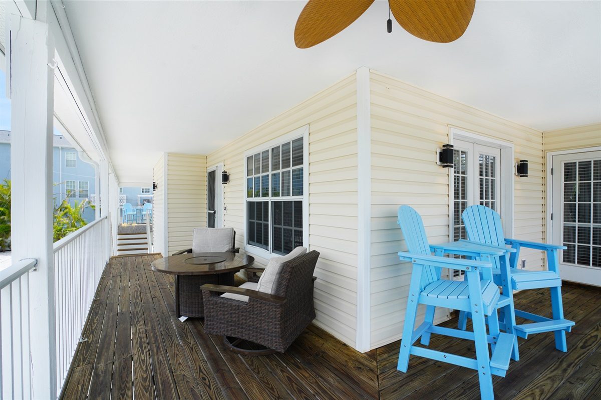 Balcony with blue bar-height chairs at Coastal Getaway