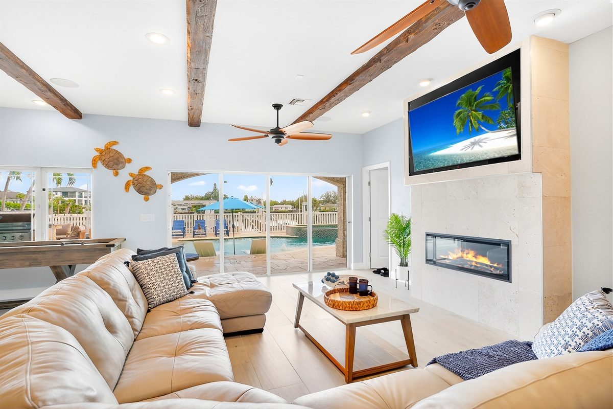 Coastal Manor living room with a fireplace, TV and large sectional sofa