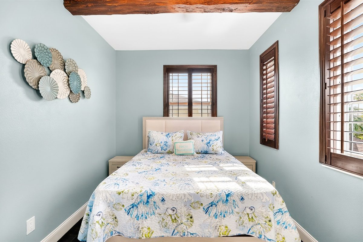 Bedroom with a queen bed and coastal decor at Coastal Manor