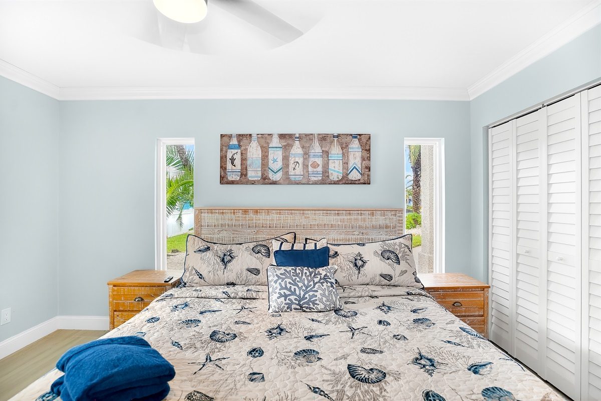 Bedroom with a king bed and seashell bedding at Coastal Manor