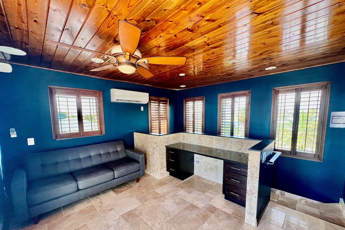 Bonus room with a wood ceiling, sofa and desk at Coastal Manor