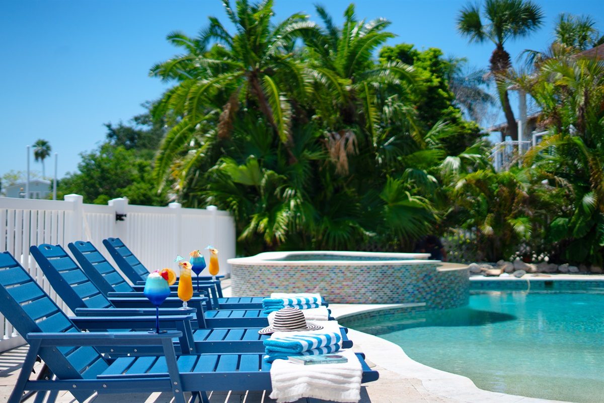 Lounge chairs beside the heated pool and spa at Coastal Manor